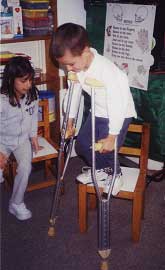 The children tried the girl's crutches.
